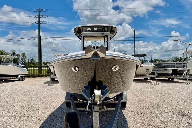 Slide: The Image of 2014 Everglades 255 Center Console boat on trailer under blue sky. - 2