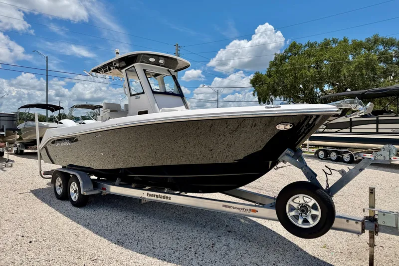 Slide: The Image of 2014 Everglades 255 Center Console boat on trailer under clear blue sky. - 3