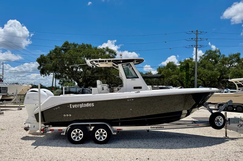 Slide: The Image of 2014 Everglades 255 Center Console boat on trailer under clear blue sky. - 4