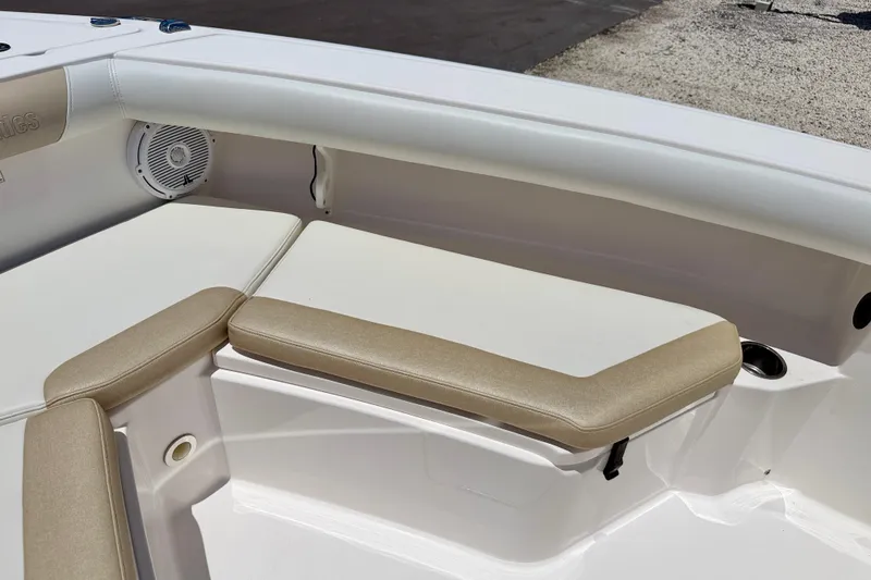 Slide: The Image of 2014 Everglades 255 Center Console boat interior with cushioned seating and speaker. - 10