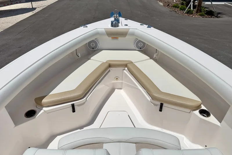 Slide: The Image of 2014 Everglades 255 Center Console boat interior with cushioned seating and speakers. - 8