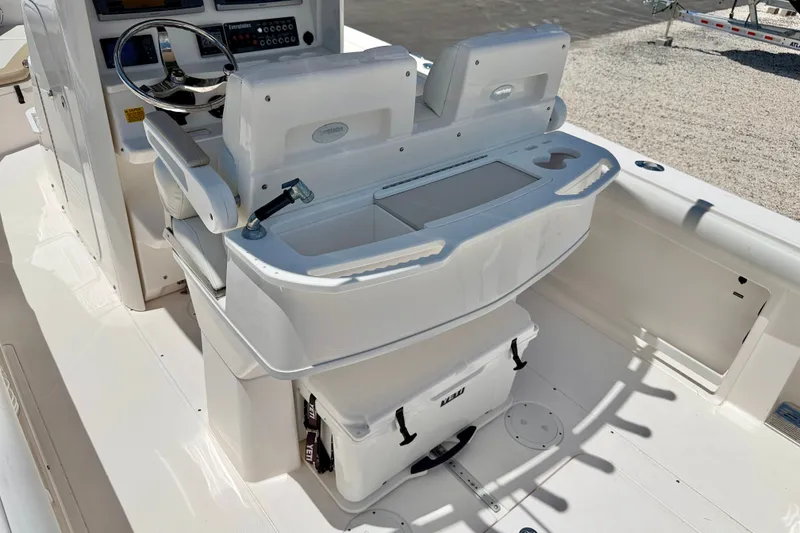 Slide: The Image of 2014 Everglades 255 Center Console boat interior with helm and seating area. - 23