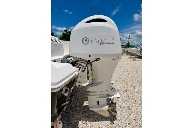 Slide: The Image of 2014 Everglades 255 Center Console with Yamaha four-stroke outboard motor, parked on gravel. - 38