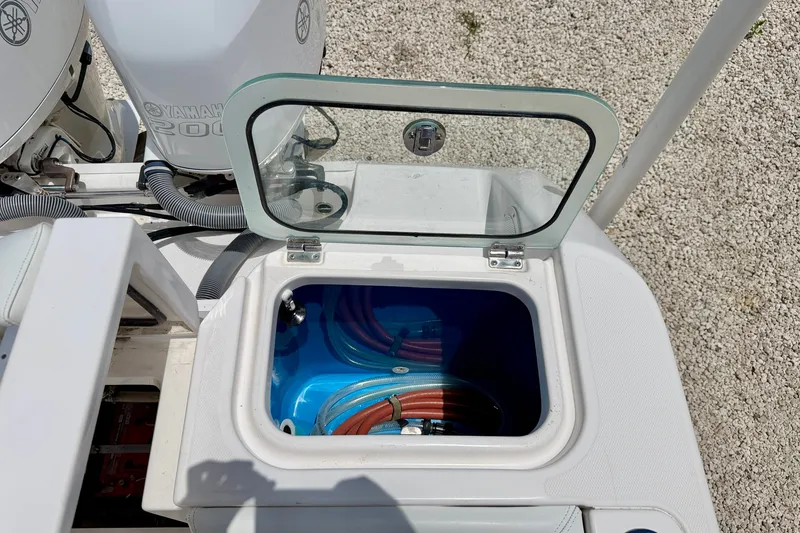 Slide: The Image of Open hatch on 2014 Everglades 255 Center Console boat, revealing storage compartment. - 32