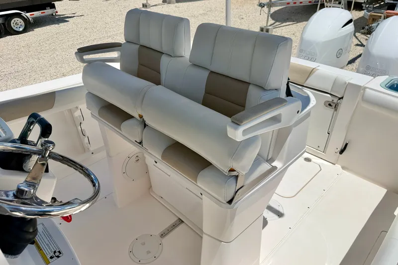 Slide: The Image of 2014 Everglades 255 Center Console boat with dual helm seats and steering wheel. - 12