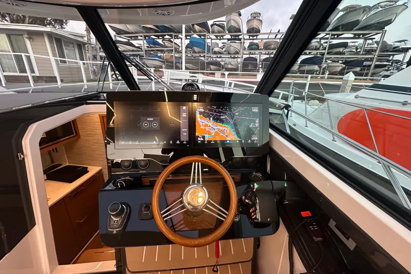Slide: The Image of Helm of 2027 Tiara Yachts 39 LE with advanced navigation displays and controls. - 13