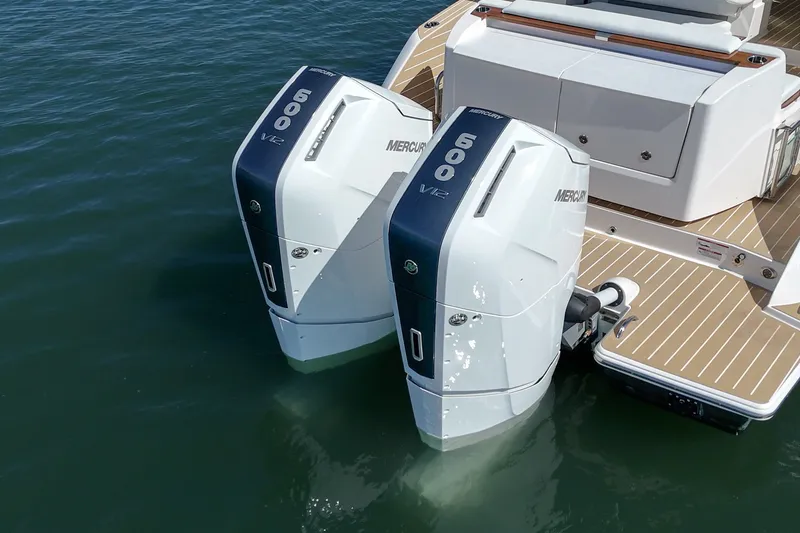 Slide: The Image of Twin Mercury 600 V12 engines on a 2027 Tiara Yachts 39 LE, docked on calm water. - 20