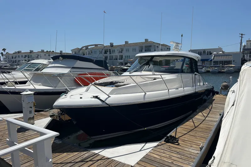 Slide: The Image of 2027 Tiara Yachts 39 LE docked at a marina, showcasing sleek design and modern features. - 15