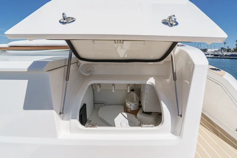 Slide: The Image of 2027 Tiara Yachts 39 LE storage compartment with open hatch, showcasing interior details. - 29