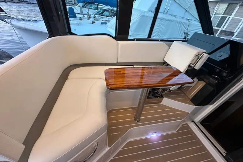 Slide: The Image of Luxurious seating area on 2027 Tiara Yachts 39 LE with elegant wood table. - 18