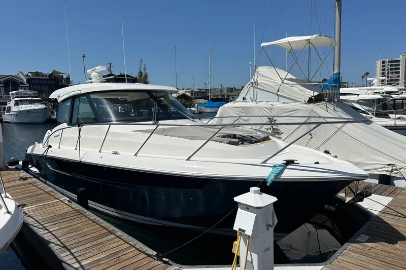 Slide: The Image of 2027 Tiara Yachts 39 LE docked at marina under clear blue sky. - 17