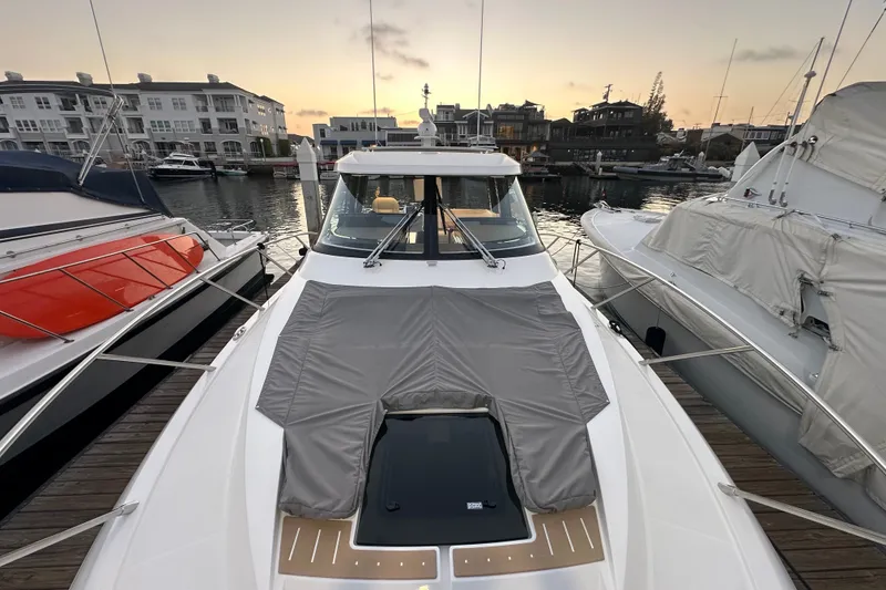 Slide: The Image of 2027 Tiara Yachts 39 LE docked at marina during sunset, showcasing sleek design. - 26