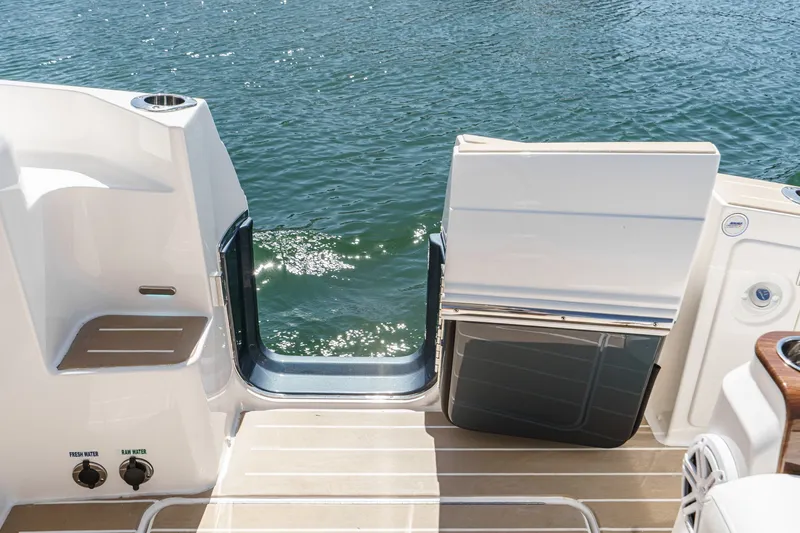 Slide: The Image of 2027 Tiara Yachts 39 LE swim platform with open gate, overlooking sparkling water. - 38