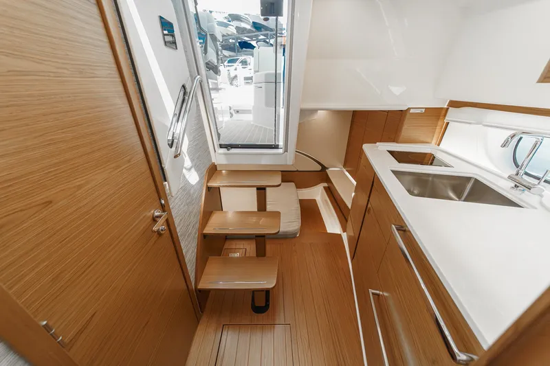 Slide: The Image of Interior of 2027 Tiara Yachts 39 LE, featuring modern wood finishes and compact kitchen area. - 71