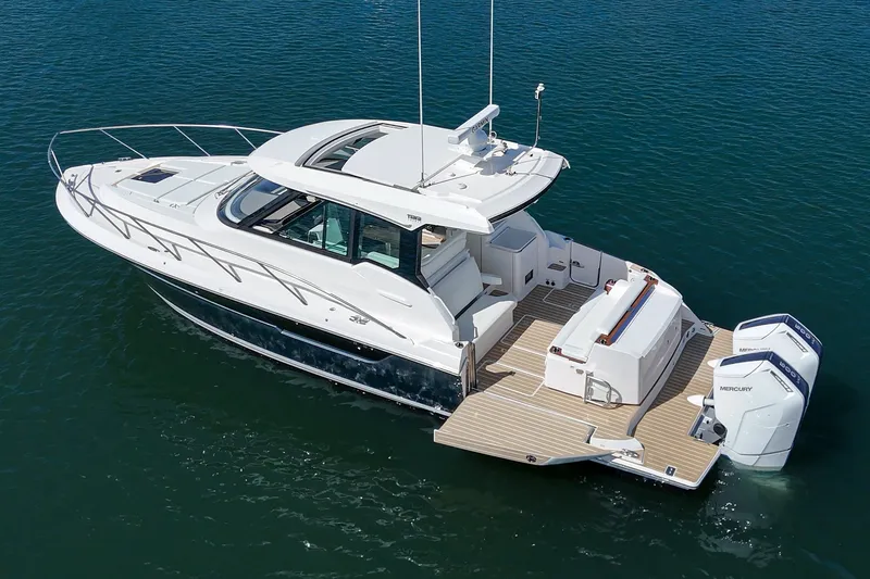 Slide: The Image of 2027 Tiara Yachts 39 LE luxury boat on calm water, showcasing sleek design and powerful engines. - 21