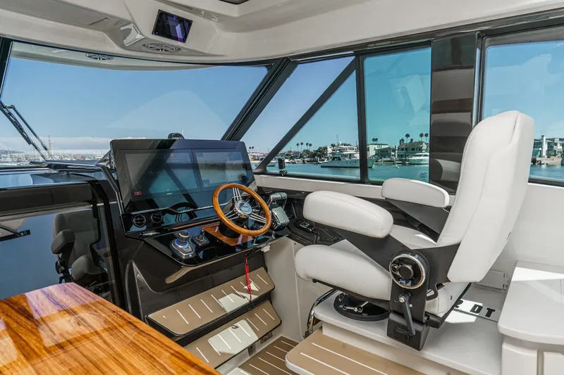 Slide: The Image of 2027 Tiara Yachts 39 LE helm with modern controls and luxurious seating. - 53