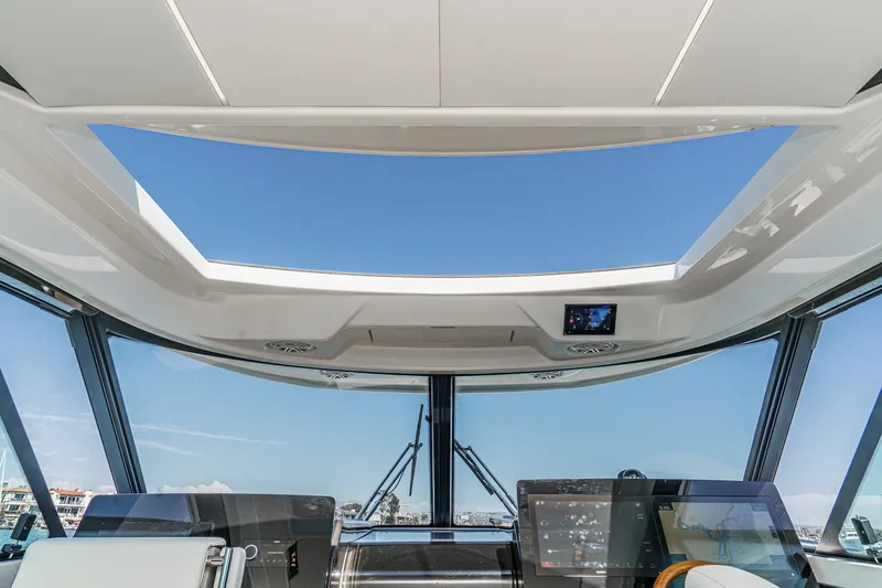 Slide: The Image of Interior view of 2027 Tiara Yachts 39 LE helm with panoramic windows and modern controls. - 56