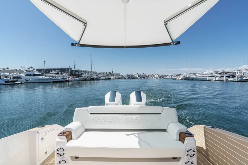 Slide: The Image of 2027 Tiara Yachts 39 LE cruising in a marina, showcasing luxury seating and dual engines. - 32