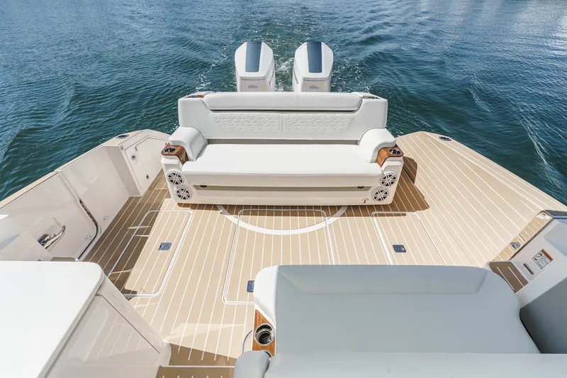 Slide: The Image of 2027 Tiara Yachts 39 LE boat deck with seating and twin engines on water. - 30