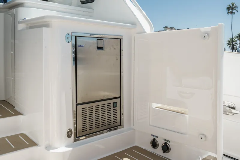 Slide: The Image of Tiara Yachts 39 LE 2027 model featuring an open storage compartment with stainless steel appliance. - 52
