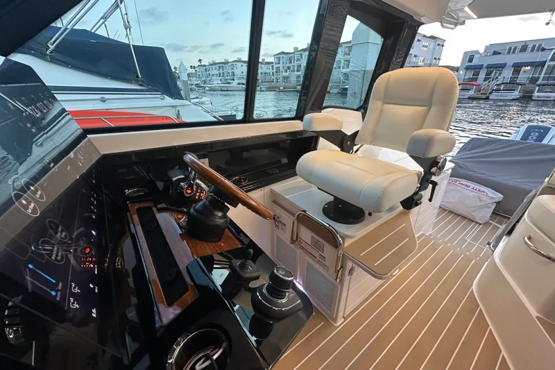 Slide: The Image of Luxurious helm of 2027 Tiara Yachts 39 LE with plush seating and modern controls. - 20