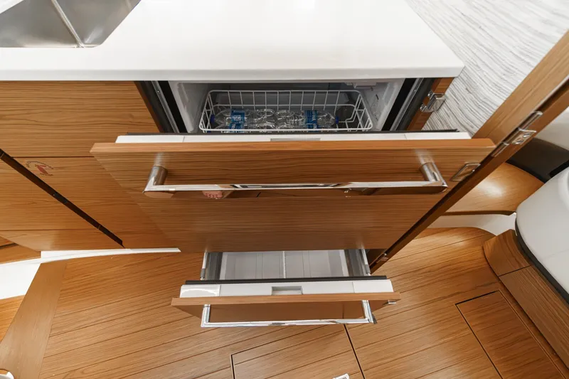 Slide: The Image of 2027 Tiara Yachts 39 LE interior with open wooden cabinetry and modern appliances. - 62