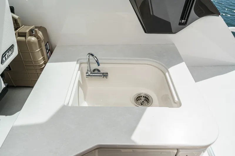 Slide: The Image of Tiara Yachts 39 LE 2027 yacht sink with modern faucet and storage area. - 51