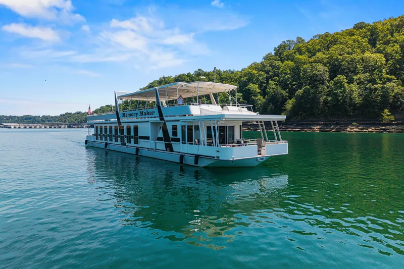 Slide: The Image of Luxurious 2016 Thoroughbred 21 x 100 houseboat on serene lake with lush forest backdrop. - 4