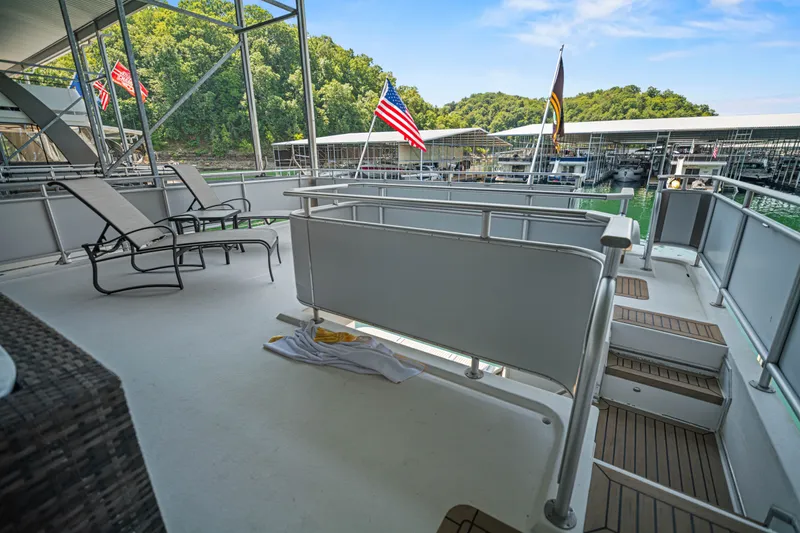 Slide: The Image of Luxurious 2016 Thoroughbred 21 x 100 houseboat deck with lounge chairs and scenic marina view. - 25