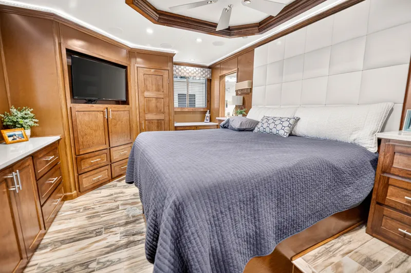 Slide: The Image of Luxurious 2016 Thoroughbred 21 x 100 bedroom with elegant wood cabinetry and modern decor. - 21