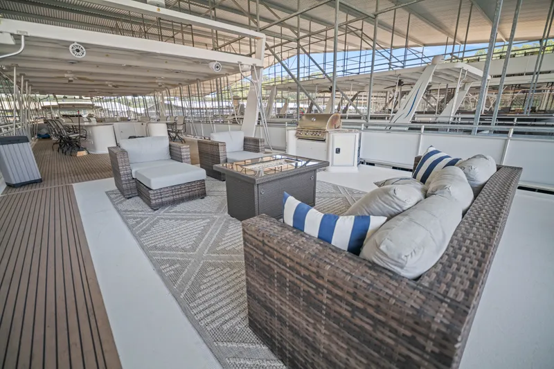 Slide: The Image of Luxurious 2016 Thoroughbred 21 x 100 houseboat deck with stylish outdoor seating and grill. - 26