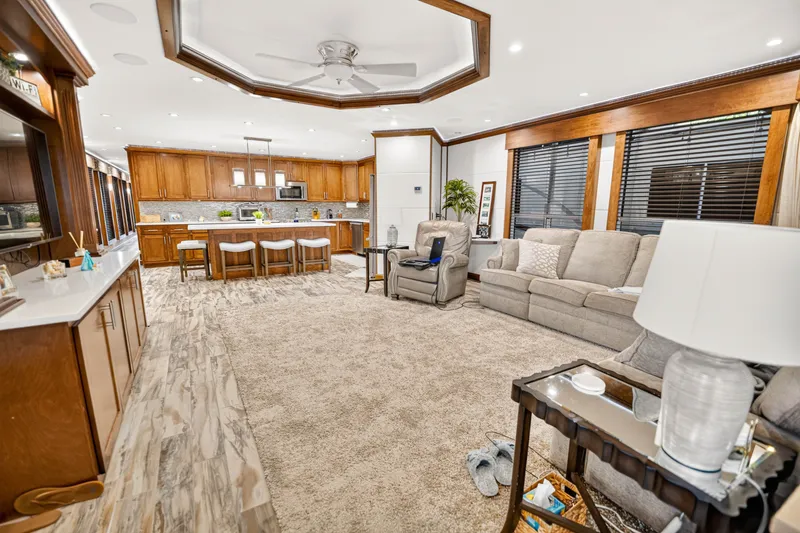 Slide: The Image of Spacious 2016 Thoroughbred 21 x 100 living area with modern kitchen and cozy seating. - 7