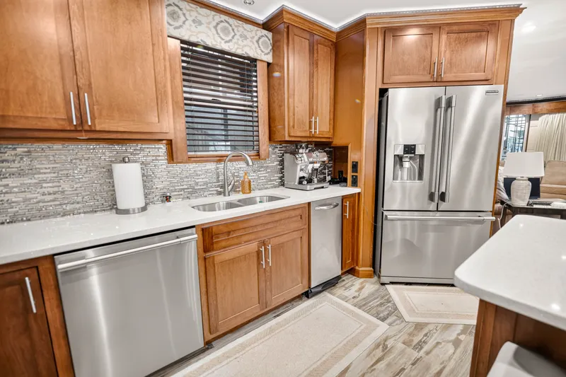 Slide: The Image of Modern kitchen with stainless steel appliances, wooden cabinets, and mosaic tile backsplash. - 19