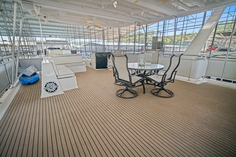 Slide: The Image of Spacious deck of 2016 Thoroughbred 21 x 100 yacht with seating and dining area. - 23