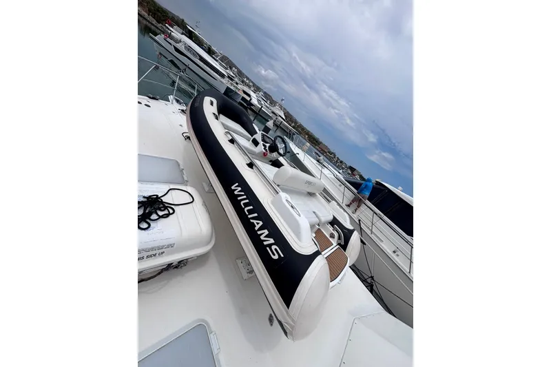 Slide: The Image of 2022 Williams Jet Tenders 345 Sports Jet docked at marina, side view. - 2
