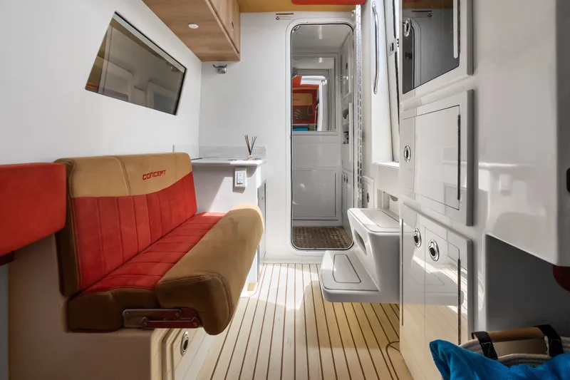 Slide: The Image of Interior of 2024 Concept 44' Open Deck boat with modern seating and cabinetry. - 44