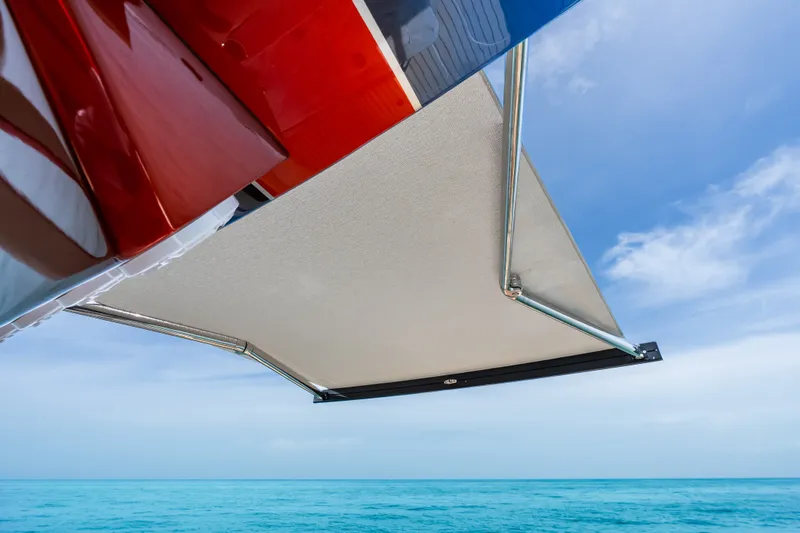 Slide: The Image of 2024 Concept 44' Open Deck boat with extended canopy over turquoise sea. - 34