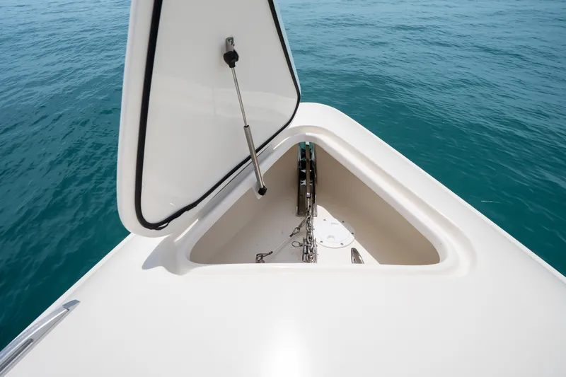 Slide: The Image of Open anchor hatch on 2024 Concept 44' Open Deck boat, floating on blue ocean water. - 39