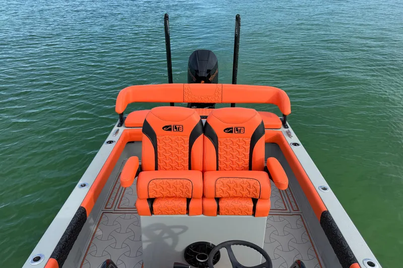 Slide: The Image of 2026 Latitude Tournament Boats 25 with vibrant orange seating on calm water. - 18