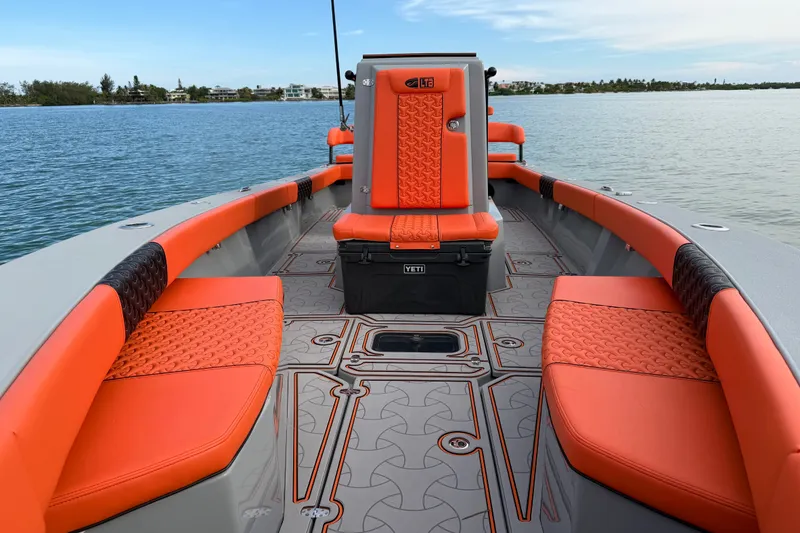 Slide: The Image of 2026 Latitude Tournament Boats 25 with vibrant orange seating on calm waters. - 16