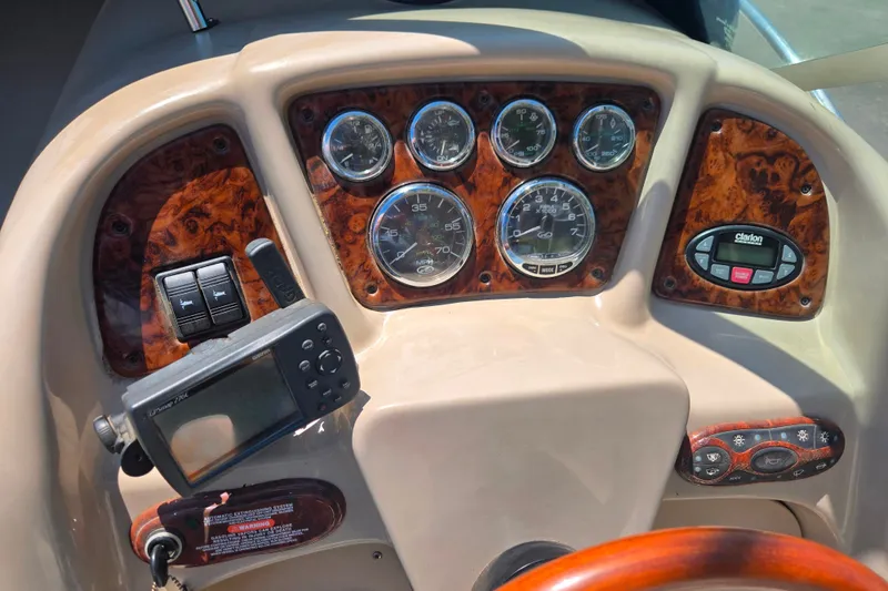 Slide: The Image of Dashboard of a 2004 Sea Ray 240 Sundancer boat with gauges and controls. - 15