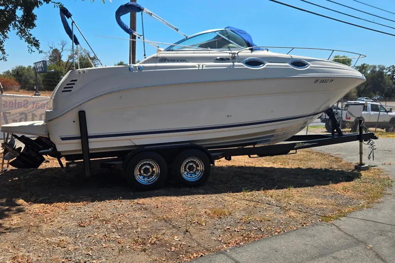 Slide: The Image of 2004 Sea Ray 240 Sundancer boat on trailer, parked outdoors. - 11