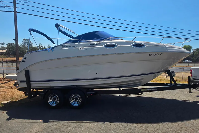 Slide: The Image of 2004 Sea Ray 240 Sundancer boat on trailer, parked outdoors. - 5