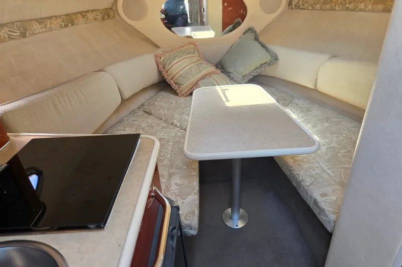 Slide: The Image of Interior of 2004 Sea Ray 240 Sundancer with cozy seating and table. - 18