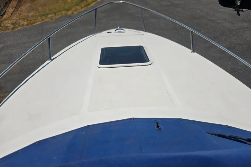 Slide: The Image of 2004 Sea Ray 240 Sundancer boat deck with hatch and railing. - 24
