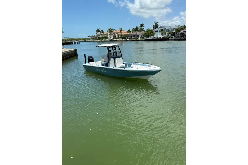 Slide: The Image of 2021 Pathfinder 2600 TRS boat on calm water near waterfront homes. - 21