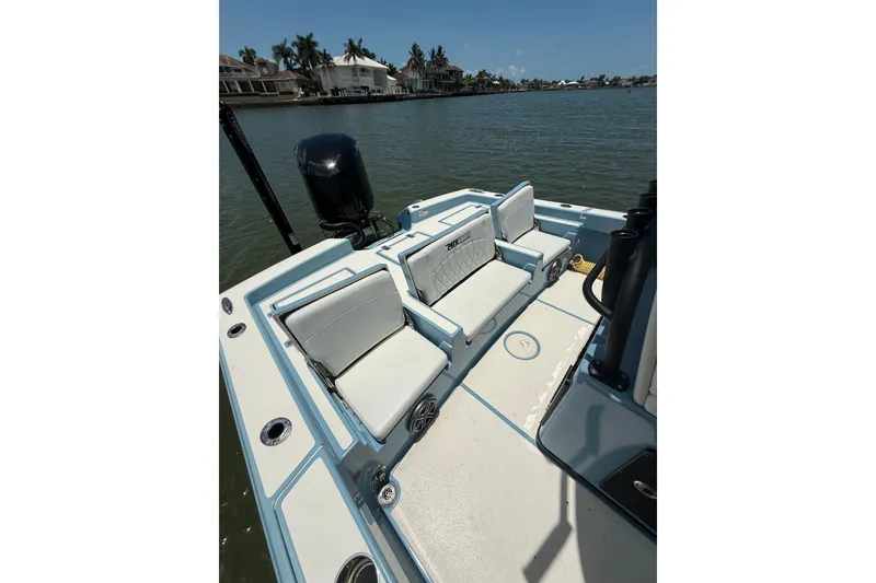 Slide: The Image of 2021 Pathfinder 2600 TRS boat interior with seating, on a calm waterway. - 16