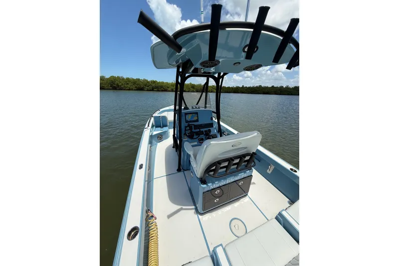 Slide: The Image of 2021 Pathfinder 2600 TRS boat on calm water, featuring a sleek design and modern console. - 19