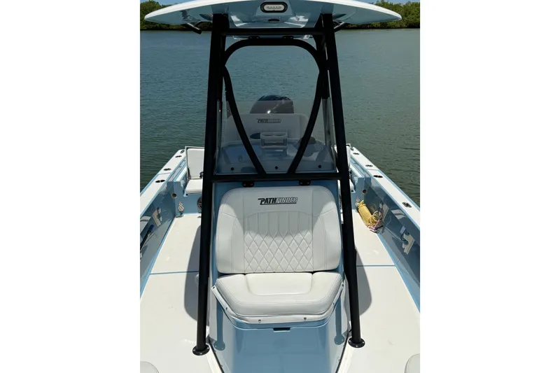 Slide: The Image of 2021 Pathfinder 2600 TRS boat interior with white seating and black frame. - 14