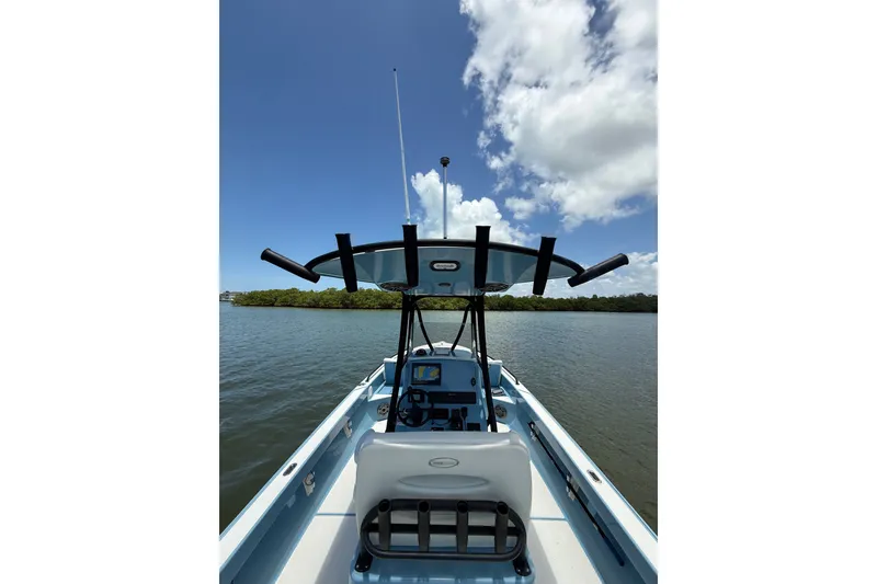 Slide: The Image of 2021 Pathfinder 2600 TRS boat on calm water under a clear blue sky. - 20